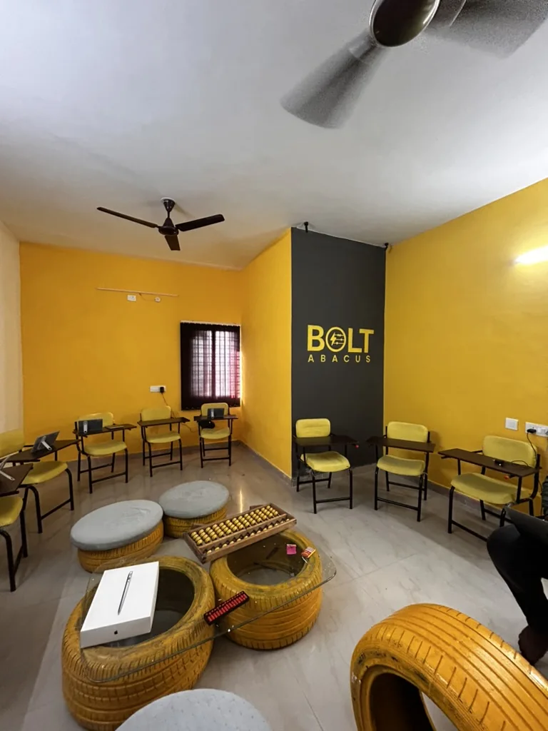 Bolt Abacus offline centre with yellow walls, tyre tables and abacus boards