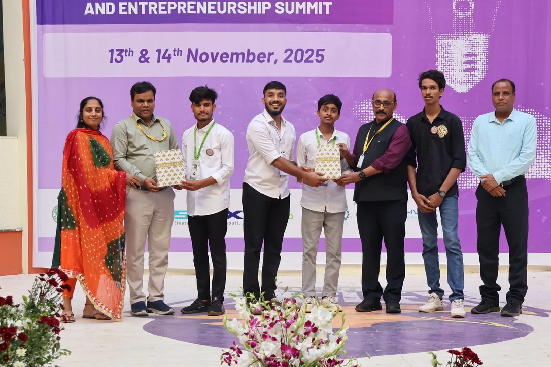 Siram presenting recognition on an entrepreneurship summit stage
