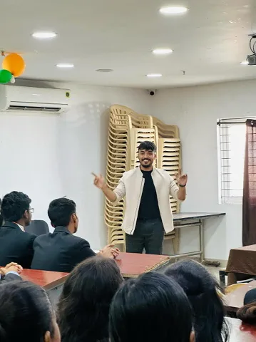 Siram speaking to students in a smaller classroom