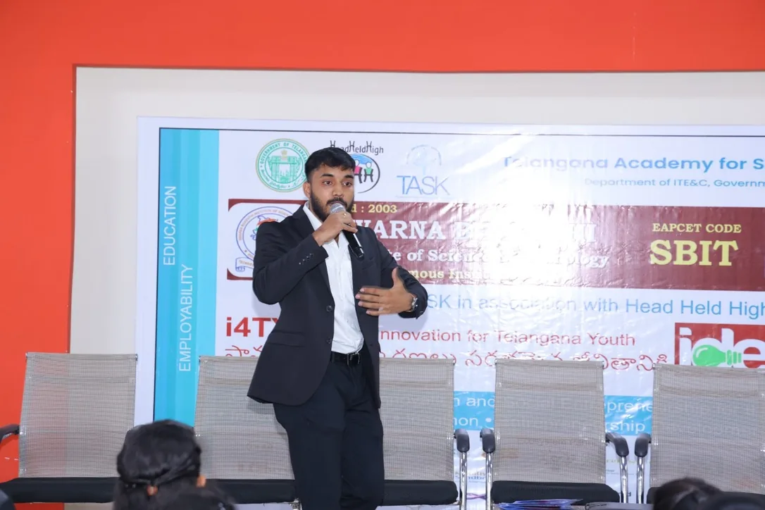 Siram speaking on stage at a TASK-associated event